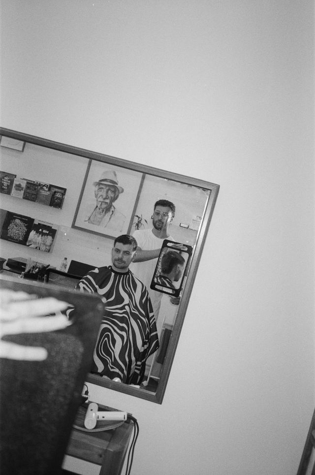 Barber at work with client